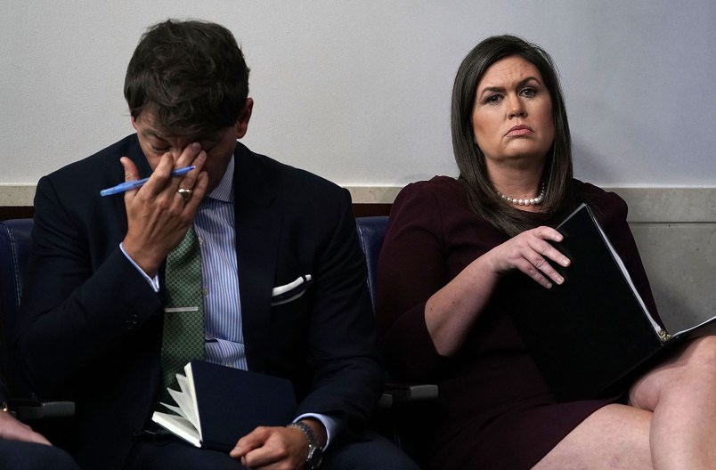 WASHINGTON, DC - OCTOBER 03:  White House Press Secretary Sarah Sanders (R) and White House Deputy Press Secretary Hogan Gidley (L) listen during a White House news briefing at the James Brady Press Briefing Room of the White House October 3, 2018 in Washington, DC. Sanders held a news briefing to answer questions from members of the White House press corps.  (Photo by Alex Wong/Getty Images) *** Local Caption *** Sarah Sanders; Hogan Gidley