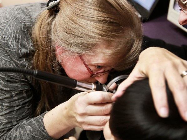 Doctor Sue Haverkamp, examining a young patient while Maria Figueroa holds her, at Erie Helping Hands Health Center, at 4747 N. Kedzie Avenue, in Chicago, on Wednesday Nov. 28, 2018.(Nuccio DiNuzzo/Chicago Tribune/TNS)