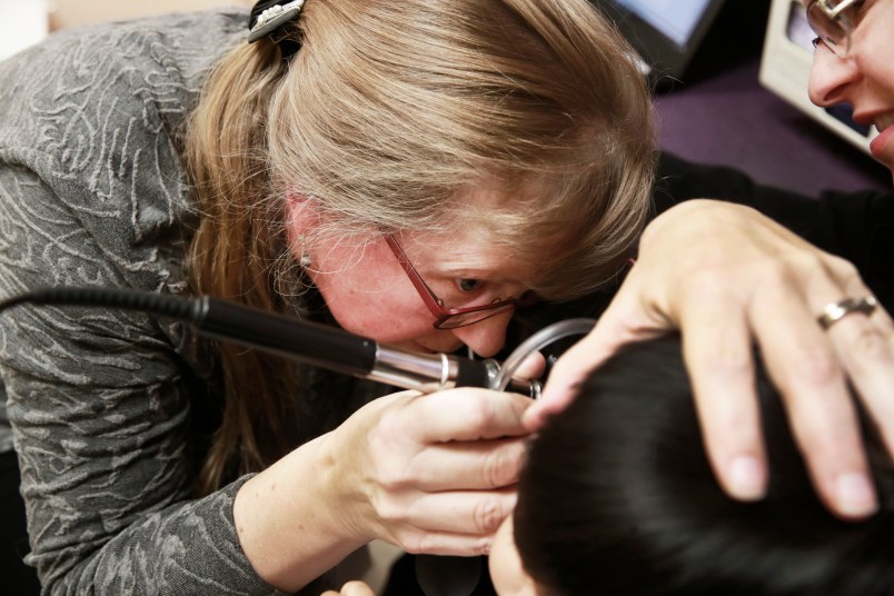 Doctor Sue Haverkamp, examining a young patient while Maria Figueroa holds her, at Erie Helping Hands Health Center, at 4747 N. Kedzie Avenue, in Chicago, on Wednesday Nov. 28, 2018.(Nuccio DiNuzzo/Chicago Tribune/TNS)
