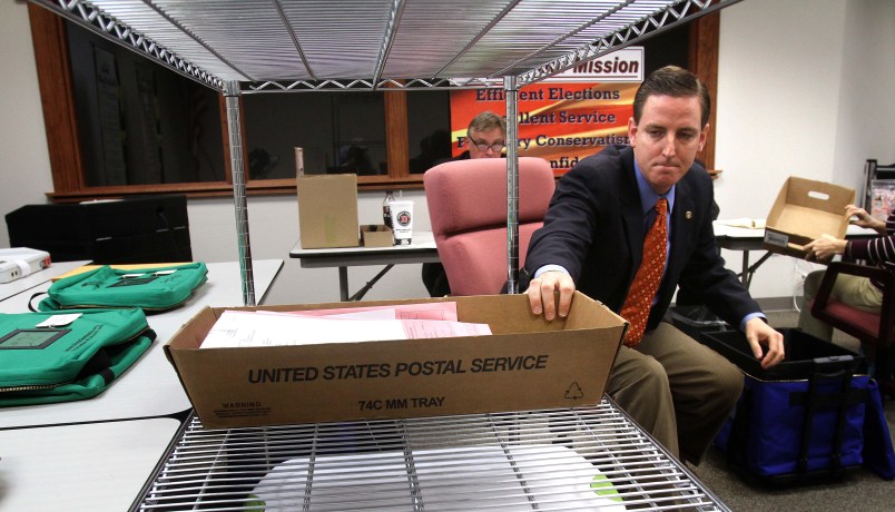 Seminole County, Fla., Elections Supervisor Michael Ertel grabs a box of ballots during the count of 600 provisional ballots, in Sanford, Florida, Thursday, November 8, 2012. In background, Richard Siwica, counsel for Mike Clelland, the challenger that is currently leading incumbent Chris Dorworth, looks on. (Joe Burbank/Orlando Sentinel/MCT)