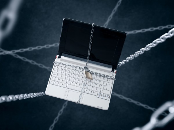 Chained laptop. Conception of sensitive data security.