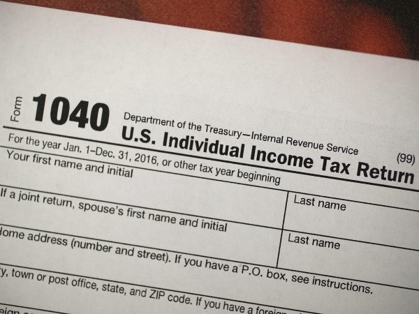 MIAMI, FL - DECEMBER 22:  A copy of a IRS 1040 tax form is seen at an H&R Block office on the day President Donald Trump signed the Republican tax cut bill in Washington, DC  on December 22, 2017 in Miami, Florida. Kathy Pickering, vice president of regulatory affairs and executive director of The Tax Institute at H&R Block released a statement about the new tax bill saying, " ItÕs going to change the way you think about and plan your income taxes. YouÕll need to take a fresh look at your individual situation to know your outcome and new strategies to use to get the best tax outcome.Ó  (Photo by Joe Raedle/Getty Images)