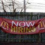 An employment sign hangs from a wooden fence on the property of a McDonald's restaurant, Thursday, Jan. 3, 2019, in Atlantic Highlands, N.J. (AP Photo/Julio Cortez)