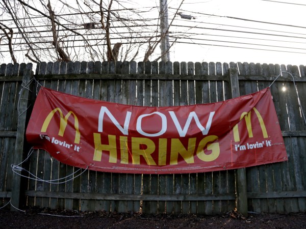 An employment sign hangs from a wooden fence on the property of a McDonald's restaurant, Thursday, Jan. 3, 2019, in Atlantic Highlands, N.J. (AP Photo/Julio Cortez)