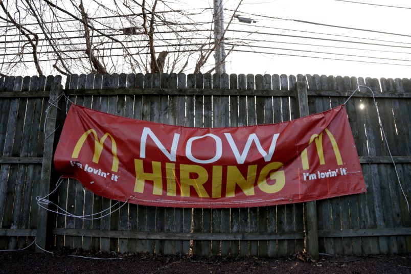 An employment sign hangs from a wooden fence on the property of a McDonald's restaurant, Thursday, Jan. 3, 2019, in Atlantic Highlands, N.J. (AP Photo/Julio Cortez)