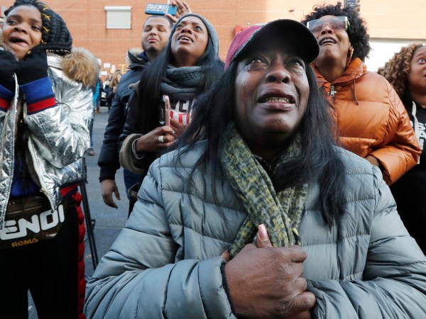 Cahana Yehudah, foreground, of the Bronx, cries as she hears the response of prisoners held inside the Metropolitan Detention Center, a federal facility with all security levels, Sunday, Feb. 3, 2019, in the Brooklyn borough of New York. The prison has been without heat, hot water, electricity and good sanitation for several days, including during the recent frigid weather. Yehudah has a brother who is serving 18 months at the prison for gun possession. (AP Photo/Kathy Willens)