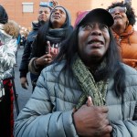 Cahana Yehudah, foreground, of the Bronx, cries as she hears the response of prisoners held inside the Metropolitan Detention Center, a federal facility with all security levels, Sunday, Feb. 3, 2019, in the Brooklyn borough of New York. The prison has been without heat, hot water, electricity and good sanitation for several days, including during the recent frigid weather. Yehudah has a brother who is serving 18 months at the prison for gun possession. (AP Photo/Kathy Willens)