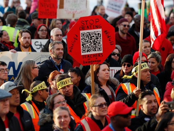 FILE - In this Jan. 30, 2019, file photo, Denver Public Schools teachers rally outside the State Capitol in Denver. Teachers plan to strike next week after Colorado officials declined to intervene in a pay dispute between the educators and the school district. State officials said Wednesday, Feb. 6, 2019, they believe the two sides are close to a negotiated agreement. Gov. Jared Polis said he expects the Denver Public Schools system and the union representing teachers to keep talking through the week to try to avoid a strike. (AP Photo/David Zalubowski, File)