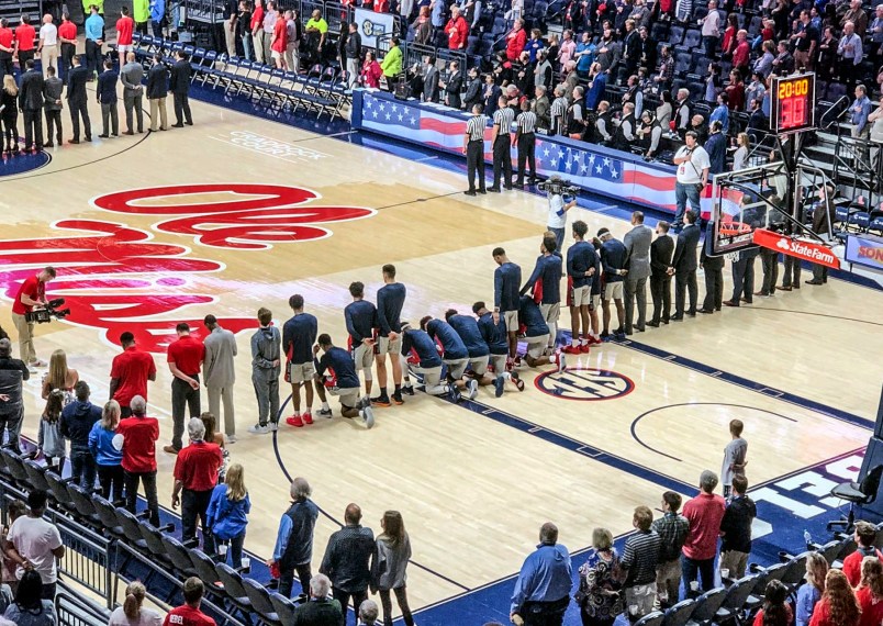 Six Mississippi basketball players take a knee during the National Anthem before the start of the game against Georgia at the Pavilion at Ole Miss in Oxford, Miss. on Saturday, February 23, 2019. (Nathanael Gabler, Oxford Eagle via AP)