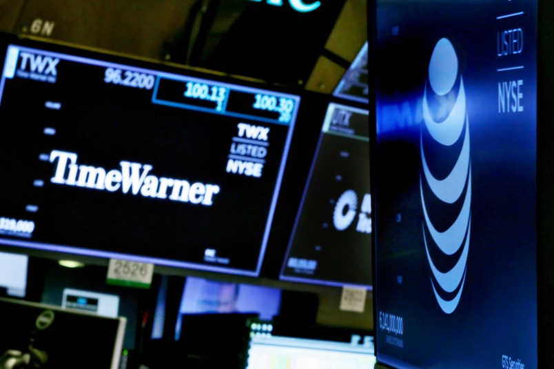 The logos for Time Warner and AT&T appear above alternate trading posts on the floor of the New York Stock Exchange, Wednesday, June 13, 2018. A federal judge has approved the $85 billion mega-merger of AT&T and Time Warner, potentially ushering in a wave of media consolidation while shaping how much consumers pay for streaming TV and movies. (AP Photo/Richard Drew)