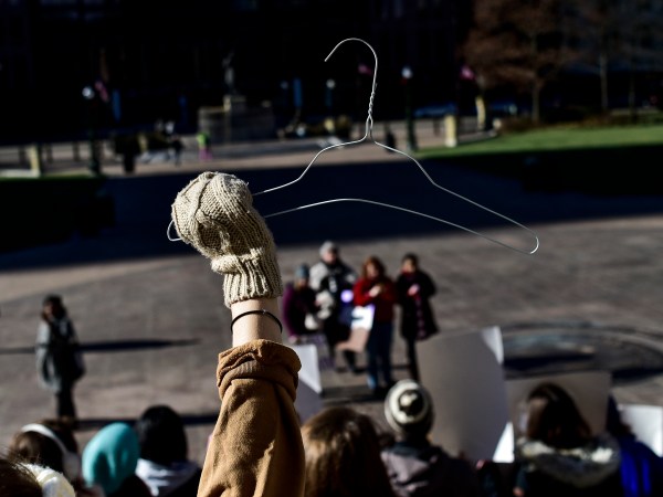 OHIO STATE HOUSE, COLUMBUS, OHIO, UNITED STATES - 2018/12/12: A protester seen holding a coat hanger which is an emblem of the pro-choice movement during a protest against the controversial Heartbeat Bill or HB258, which bans abortion once a fetal heartbeat is detected. The bill would make it much more difficult for women to seek an abortion in the state of Ohio. The bill was passed by members of the Ohio Senate with a vote of 18-13. Outgoing Ohio Governor John Kasich has said he would veto any such bill should it be passed by the Senate. (Photo by Matthew Hatcher/SOPA Images/LightRocket via Getty Images)
