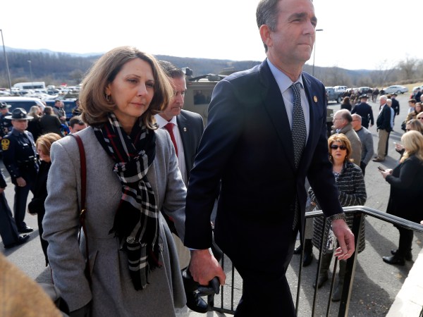 Virginia Gov. Ralph Northam, left,  and his wife Pam, left, leave the funeral of fallen Virginia State Trooper Lucas B. Dowell after the church service for the funeral at the Chilhowie Christian Church in Chilhowie, Va., Saturday, Feb. 9, 2019. Dowell was killed  in the line of duty earlier in the week. (AP Photo/POOL/Steve Helber)