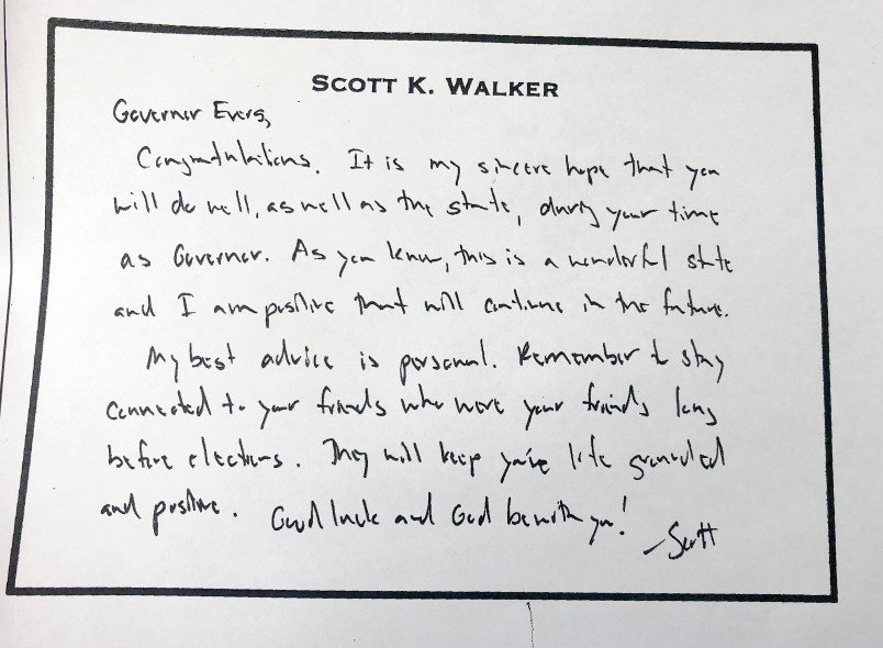 This March 4, 2019 photo shows a hand written note that former Wisconsin Gov. Scott Walker left for his successor, Tony Evers just before he left office in January. Evers on Monday released the note after initially refusing an Associated Press open records request for the document. (AP Photo/Scott Bauer)