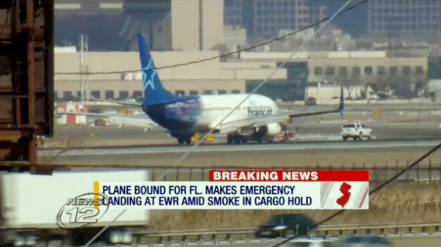 In this image taken from video provided by News12 New Jersey, Air Transat Flight 942 is towed along the runway at Newark Liberty International Airport, Saturday, March 9, 2019 in Newark NJ. The Boeing 737 with 189 passengers aboard made an emergency landing after a possible fire in the cargo hold was reported. Two passengers suffered minor injuries. No fire was found and the cause of the smoke remains under investigation. (News12 New Jersey via AP)