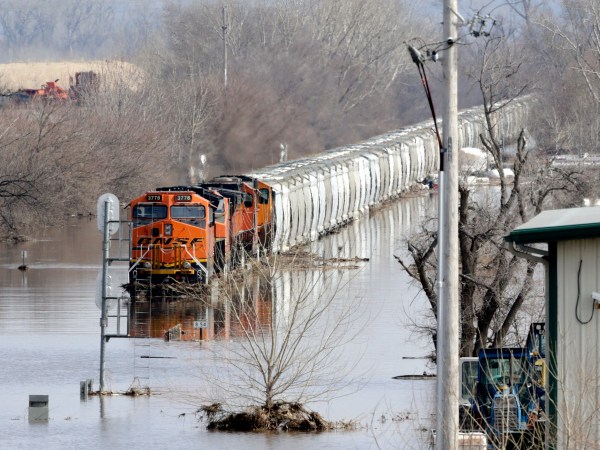 A BNSF train sits in flood waters from the Platte River, in Plattsmouth, Neb., Sunday, March 17, 2019.  Hundreds of people remained out of their homes in Nebraska, but rivers there were starting to recede. The National Weather Service said the Elkhorn River remained at major flood stage but was dropping. (AP Photo/Nati Harnik)