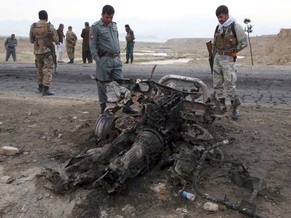 Afghan security forces gather at the site a day after an a Suicide attack near the Bagram Air Base, north of Kabul, Afghanistan, Tuesday, April 10, 2019. Three American service members and a U.S. contractor were killed when their convoy hit a roadside bomb on Monday near the main U.S. base in Afghanistan, the U.S. forces said. The Taliban claimed responsibility for the attack. (AP Photo/Rahmat Gul)