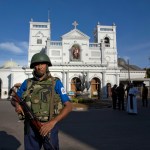 Sri Lankan air force officers and clergy stand outside St. Anthony's Shrine a day after a blast in Colombo, Sri Lanka, Monday, April 22, 2019. More than two hundred people were killed and hundreds more injured in eight blasts that rocked churches and hotels in and just outside Sri Lanka's capital on Easter Sunday.(AP Photo/Gemunu Amarasinghe)