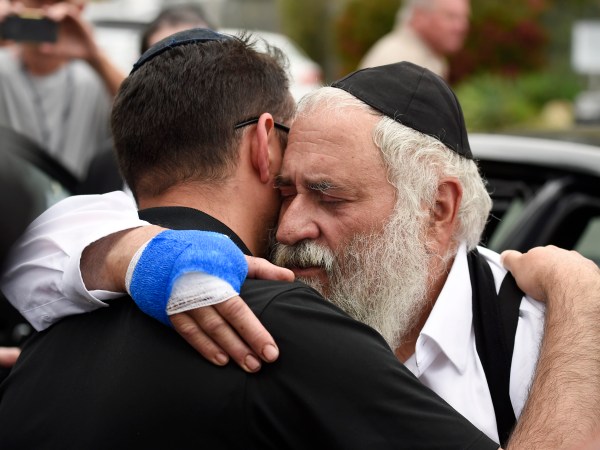 Rabbi Yisroel Goldstein, right, is hugged as he leaves a news conference at the Chabad of Poway synagogue, Sunday, April 28, 2019, in Poway, Calif. A man opened fire Saturday inside the synagogue near San Diego as worshippers celebrated the last day of a major Jewish holiday. (AP Photo/Denis Poroy)