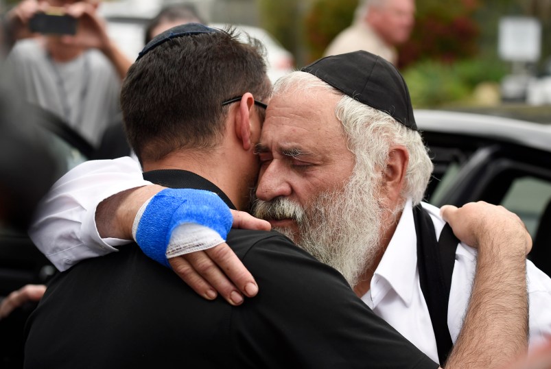 Rabbi Yisroel Goldstein, right, is hugged as he leaves a news conference at the Chabad of Poway synagogue, Sunday, April 28, 2019, in Poway, Calif. A man opened fire Saturday inside the synagogue near San Diego as worshippers celebrated the last day of a major Jewish holiday. (AP Photo/Denis Poroy)