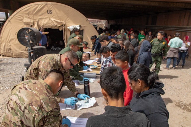 U.S. Border Patrol agents, including members of U.S. Border Patrol's BORSTAR teams (in tactical uniforms) provide food, water and medical screening to scores of migrants at a processing center after crossing the international border between the United States and Mexico in El Paso, Texas, March 22, 2019. Large groups of immigrants most often surrender to border patrol agents immediately after arriving on U.S. soil. U.S. Customs and Border Protection photo by Mani Albrecht