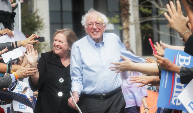 LOS ANGELES, CALIFORNIA - MARCH 23: 2020 Democratic presidential candidate U.S. Sen. Bernie Sanders (I-VT), C, arrives with his wife Jane at a campaign rally in Grand Park on March 23, 2019 in Los Angeles, California. Sanders, who is so far the top Democratic candidate in the race, is making the rounds in California which is considered a crucial 'first five' primary state by the Sanders campaign. California will hold on early primary on March 3, 2020. (Photo by Mario Tama/Getty Images)