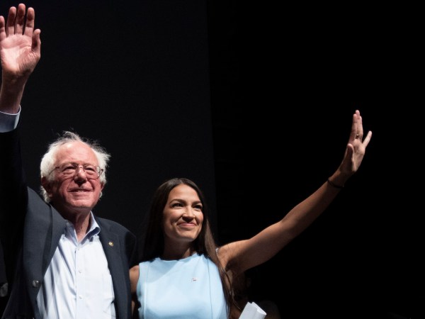 WICHITA, KA - JULY 20: James Thompson, Senator Bernie Sanders and Alexandria Ocasio-Cortez,  wave to the crowd at the end of a campaign rally in Wichita, Kansas on July 20, 2018.  (Photo by J Pat Carter for the Washington Post)
