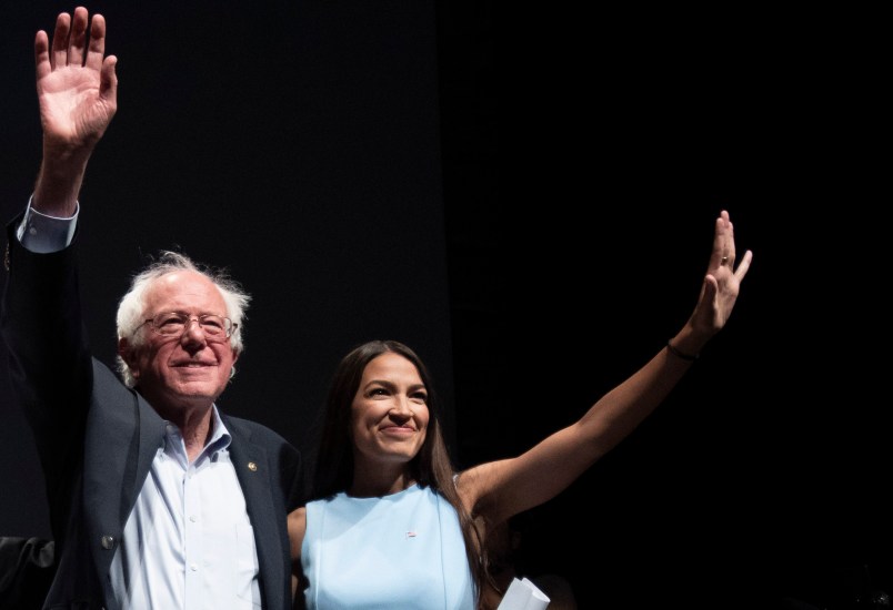 WICHITA, KA - JULY 20: James Thompson, Senator Bernie Sanders and Alexandria Ocasio-Cortez,  wave to the crowd at the end of a campaign rally in Wichita, Kansas on July 20, 2018.  (Photo by J Pat Carter for the Washington Post)