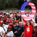 WILKES BARRE, PA - AUGUST 02: David Reinert holds up a large "Q" sign while waiting in line on August 2, 2018 at the Mohegan Sun Arena at Casey Plaza in Wilkes Barre, Pennsylvania to see President Donald J. Trump at his rally. "Q" is a conspiracy theory group that has been seen at recent rallies.    (Photo by Rick Loomis/Getty Images)
