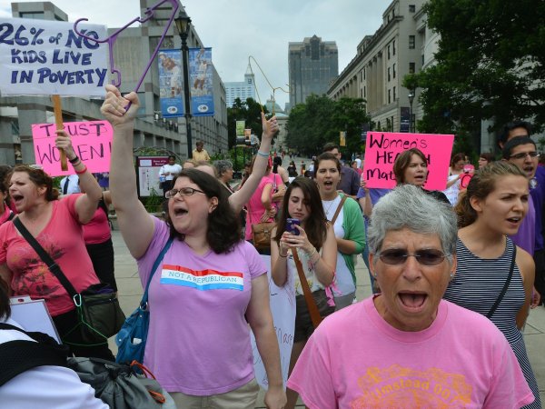 Ruth Bromer, 63 of Raleigh, North Carolina (foreground) and Jennifer Hesse, 34, of Cary (center) shout slogans on the BiCentennial Plaza  across from the Legislative Building as the North Carolina Senate gave its approval to a series of abortion restrictions Wednesday, July 3, 2013 in Raleigh, North Carolina. The bill, when originally introduced prohibited the recognition of foreign law, such as Islamic Sharia law, in family courts, was changed Tuesday with little public notice and the new bill titled the Family, Faith and Freedom Protection Act, added anti-abortion legislation. Senators voted 29-12 to approve House Bill 695. (Chuck Liddy/Raleigh News & Observer/MCT)