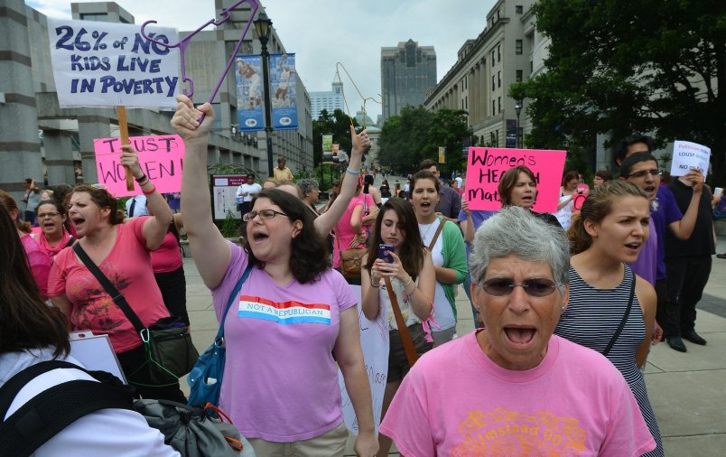 Ruth Bromer, 63 of Raleigh, North Carolina (foreground) and Jennifer Hesse, 34, of Cary (center) shout slogans on the BiCentennial Plaza  across from the Legislative Building as the North Carolina Senate gave its approval to a series of abortion restrictions Wednesday, July 3, 2013 in Raleigh, North Carolina. The bill, when originally introduced prohibited the recognition of foreign law, such as Islamic Sharia law, in family courts, was changed Tuesday with little public notice and the new bill titled the Family, Faith and Freedom Protection Act, added anti-abortion legislation. Senators voted 29-12 to approve House Bill 695. (Chuck Liddy/Raleigh News & Observer/MCT)