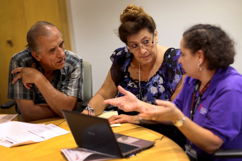 MIAMI, FL - OCTOBER 08:  Affordable Care Act navigator Nini Hadwen (R) speaks with Jorge Hernandez (L) and Marta Aguirre as they shop for health insurance during a navigation session put on by the Epilepsy Foundation Florida to help people sign up for health insurance under the Affordable Care Act on October 8, 2013 in Miami, Florida. The United States government continues to be partially shut down as Republicans hold out hope to cut funding for the Affordable Care Act.  (Photo by Joe Raedle/Getty Images)