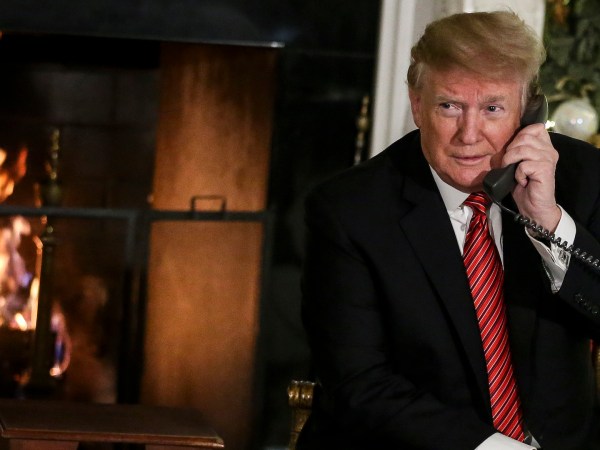 WASHINGTON, DC - DECEMBER 24: President Donald Trump and first lady Melania Trump speak on the phone with children as they track Santa Claus with the North American Aerospace Defense Command, NORAD, on Christmas Eve in the State Dinning Room of the White House on December 24, 2018 in Washington, DC.(Photo by Oliver Contreras/For The Washington Post)
