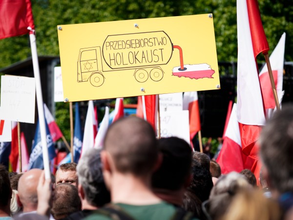 A sign is seen during the protest against the JUST act in Warsaw, Poland on May 11, 2019. Several thousand people gathered in front of the Prime Minister's office and marched to the US embassy to protest the Justice for Uncompensated Survivors Today (JUST) act 447 which requires the US State Department to report on progress made by 47 countries on compensation of assests seized during WWII for Holocaust survivors. Poland is the only European country that has not yet passed any laws to regulate compensation for rightful owners of seized properties. (Photo by Jaap Arriens/NurPhoto)