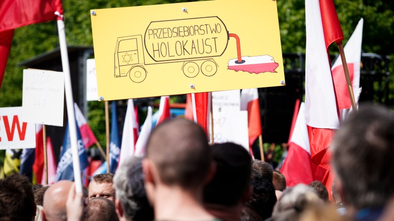 A sign is seen during the protest against the JUST act in Warsaw, Poland on May 11, 2019. Several thousand people gathered in front of the Prime Minister's office and marched to the US embassy to protest the Justice for Uncompensated Survivors Today (JUST) act 447 which requires the US State Department to report on progress made by 47 countries on compensation of assests seized during WWII for Holocaust survivors. Poland is the only European country that has not yet passed any laws to regulate compensation for rightful owners of seized properties. (Photo by Jaap Arriens/NurPhoto)