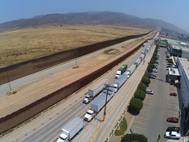 TIJUANA, MEXICO - MAY 31: Trucks wait in line to enter the United States on May 31, 2019 in Tijuana, Mexico. President Donald Trump has proposed a 5% tariff on Mexican goods entering the U.S. unless they help stop illegal immigration. (Photo by Sandy Huffaker/Getty Images)