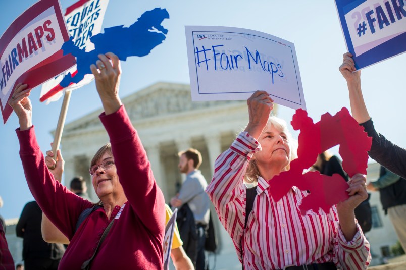 UNITED STATES - OCTOBER 03: Shirley Connuck, right, holds up a sign representing a district in Texas, as the Supreme Court hears a case on partisan gerrymandering by state legislatures on October 3, 2017. (Photo By Tom Williams/CQ Roll Call)