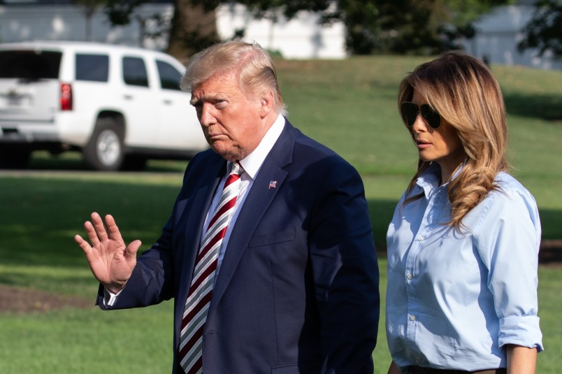U.S. President Donald Trump waves with First Lady Melania Trump by his side as they walk on the South Lawn of the White House after arriving on Marine One in Washington, DC., on Sunday, August 4, 2019.  (Photo by Cheriss May/NurPhoto)
