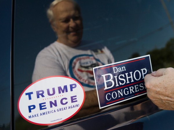 UNITED STATES - AUGUST 10: David Peglau puts a bump sticker on his car supporting Dan Bishop, Republican candidate for North Carolina's 9th District, outside of Robin's On Main diner in Hope Mills, N.C., on Friday, August 10, 2019. (Photo By Tom Williams/CQ Roll Call)