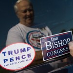 UNITED STATES - AUGUST 10: David Peglau puts a bump sticker on his car supporting Dan Bishop, Republican candidate for North Carolina's 9th District, outside of Robin's On Main diner in Hope Mills, N.C., on Friday, August 10, 2019. (Photo By Tom Williams/CQ Roll Call)