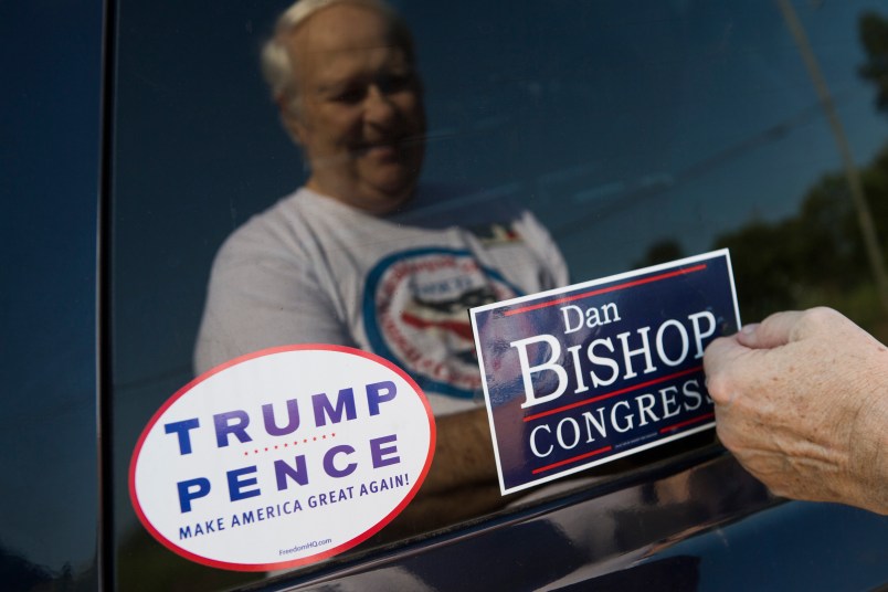 UNITED STATES - AUGUST 10: David Peglau puts a bump sticker on his car supporting Dan Bishop, Republican candidate for North Carolina's 9th District, outside of Robin's On Main diner in Hope Mills, N.C., on Friday, August 10, 2019. (Photo By Tom Williams/CQ Roll Call)