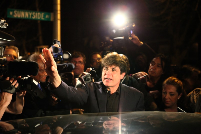 Former Gov. Rod Blagojevich waves to the crowd in front of his home as he leaves for prison, Thursday, March 15, 2012 in Chicago. Blagojevich is resentencing today. (William DeShazer/Chicago Tribune/TNS)