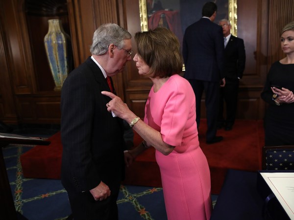 WASHINGTON, DC - DECEMBER 08:  U.S. Senate Majority Leader Mitch McConnell (R-KY) speaks with House Minority Leader Rep. Nancy Pelosi (R) (D-CA) following an event marking the passage of the 21st Century Cures Act at the U.S. Capitol December 8, 2016 in Washington, DC. The bill, passed with strong bipartisan support, provides funding for cancer research, the fight against the epidemic of opioid abuse, mental health treatment, aids the Food and Drug Administration in expediting drug approvals and pushes for better use of technology in medicine.  (Photo by Win McNamee/Getty Images)