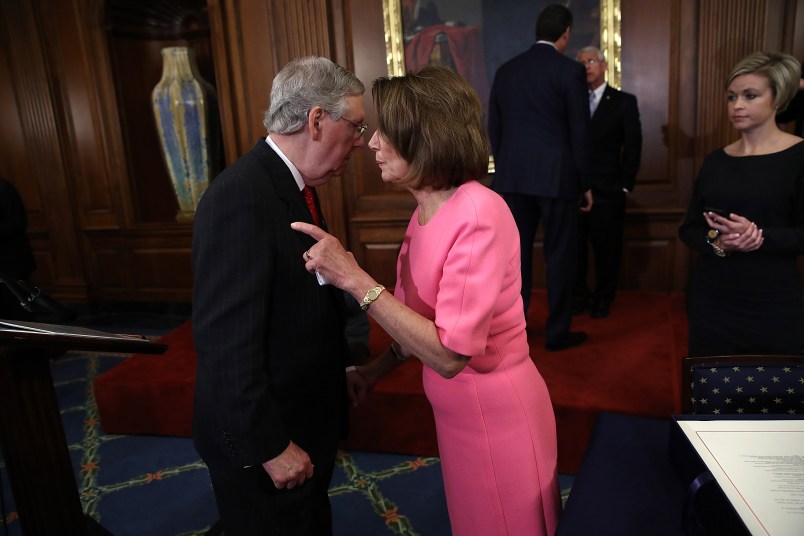 WASHINGTON, DC - DECEMBER 08:  U.S. Senate Majority Leader Mitch McConnell (R-KY) speaks with House Minority Leader Rep. Nancy Pelosi (R) (D-CA) following an event marking the passage of the 21st Century Cures Act at the U.S. Capitol December 8, 2016 in Washington, DC. The bill, passed with strong bipartisan support, provides funding for cancer research, the fight against the epidemic of opioid abuse, mental health treatment, aids the Food and Drug Administration in expediting drug approvals and pushes for better use of technology in medicine.  (Photo by Win McNamee/Getty Images)