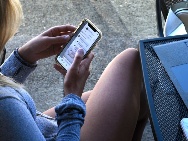 JACKSONVILLE, OREGON - JUNE 19, 2019: A young woman uses her smartphone as she sits outside a coffee shop in Jacksonville, Oregon. (Photo by Robert Alexander/Getty Images)