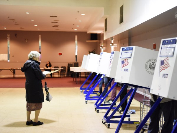 NEW YORK, Nov. 7, 2018 -- A voter walks to the booth to fill in her ballot at a polling station in Staten Island of New York Nov. 6, 2018. The U.S. Republican Party on Tuesday managed to maintain a Senate majority in the midterm elections, while the Democrats wrestled the House majority from the Republicans, according to projections of multiple news outlets. (Xinhua/Han Fang)