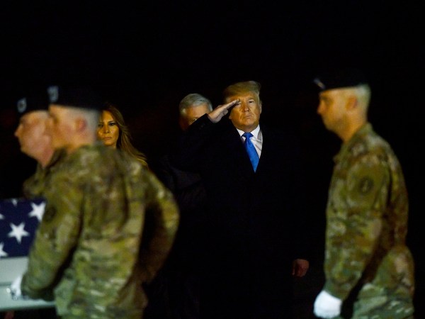 DOVER, DE - NOVEMBER 21:  U.S. President Donald J. Trump and First Lady Melania Trump salute as military personnel carry a transfer case for fallen service member, U.S. Army Chief Warrant Officer 2 Kirk T. Fuchigami, 25, during a dignified transfer at Dover Air Force Base on November 21, 2019 in Dover, Delaware.  Fuchigami died Wednesday along with Chief Warrant Officer 2  David C. Knadle, 33, in Logar province, Afghanistan, when their helicopter crashed while providing security for troops on the ground,  according to a Department of Defense release.  The incident is under investigation.  (Photo by Mark Makela/Getty Images)