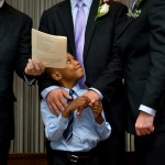 WASHINGTON, DC  - JULY 26:  (L-R)  Newly-adopted son Cardel, 6 smiles at his two adoptive parents,  Kelly Vielmo (C) and Jack Montgomery (R) get married by Rev. __________ in Washington, DC on Thursday, July 26, 2012.  The same sex couple legally adopted Cardel and his two sisters Ravyn, 2 and Raine, 3 earlier in the day.  The children are all siblings from the same mother and have been living with Jack and Kelly for about a year now.  They decided to do both events on the same day out of convenience for family members who came to town.   (Photo by Linda Davidson / The Washington Post)
