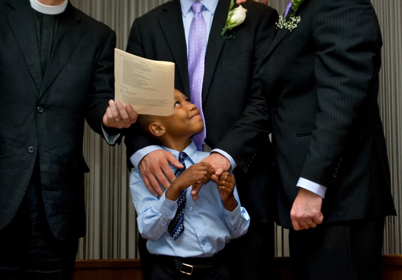 WASHINGTON, DC  - JULY 26:  (L-R)  Newly-adopted son Cardel, 6 smiles at his two adoptive parents,  Kelly Vielmo (C) and Jack Montgomery (R) get married by Rev. __________ in Washington, DC on Thursday, July 26, 2012.  The same sex couple legally adopted Cardel and his two sisters Ravyn, 2 and Raine, 3 earlier in the day.  The children are all siblings from the same mother and have been living with Jack and Kelly for about a year now.  They decided to do both events on the same day out of convenience for family members who came to town.   (Photo by Linda Davidson / The Washington Post)