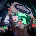 NEW YORK, UNITED STATES - 2019/12/17: Protester holding a sign at the rally in Times Square. The night before the House of Representatives takes a somber vote to impeach Trump, hundreds of thousands of Americans joined the "Nobody Is Above the Law" coalition at more than 500 rallies planned around the country, calling on the U.S. House to vote to impeach President Donald Trump. In New York City thousands of protesters took to the streets, gathering at Father Duffy Square in Times Square, and marched down Broadway to Union Square. (Photo by Erik McGregor/LightRocket via Getty Images)