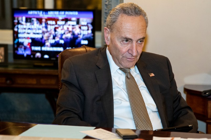 WASHINGTON, DC - DECEMBER 18: Senate Minority Leader Chuck Schumer (D-NY) allows press photographers an opportunity to photograph him watching the House of Representatives vote on the two Articles of Impeachment of President Donald Trump in his office on December 18, 2019 in Washington, DC. After a long process the House has brought two Articles of Impeachment, abuse of power and obstruction of Congress, up for a vote which will send them to the Senate for a trial. (Photo by Samuel Corum/Getty Images) *** Local Caption *** Chuck Schumer